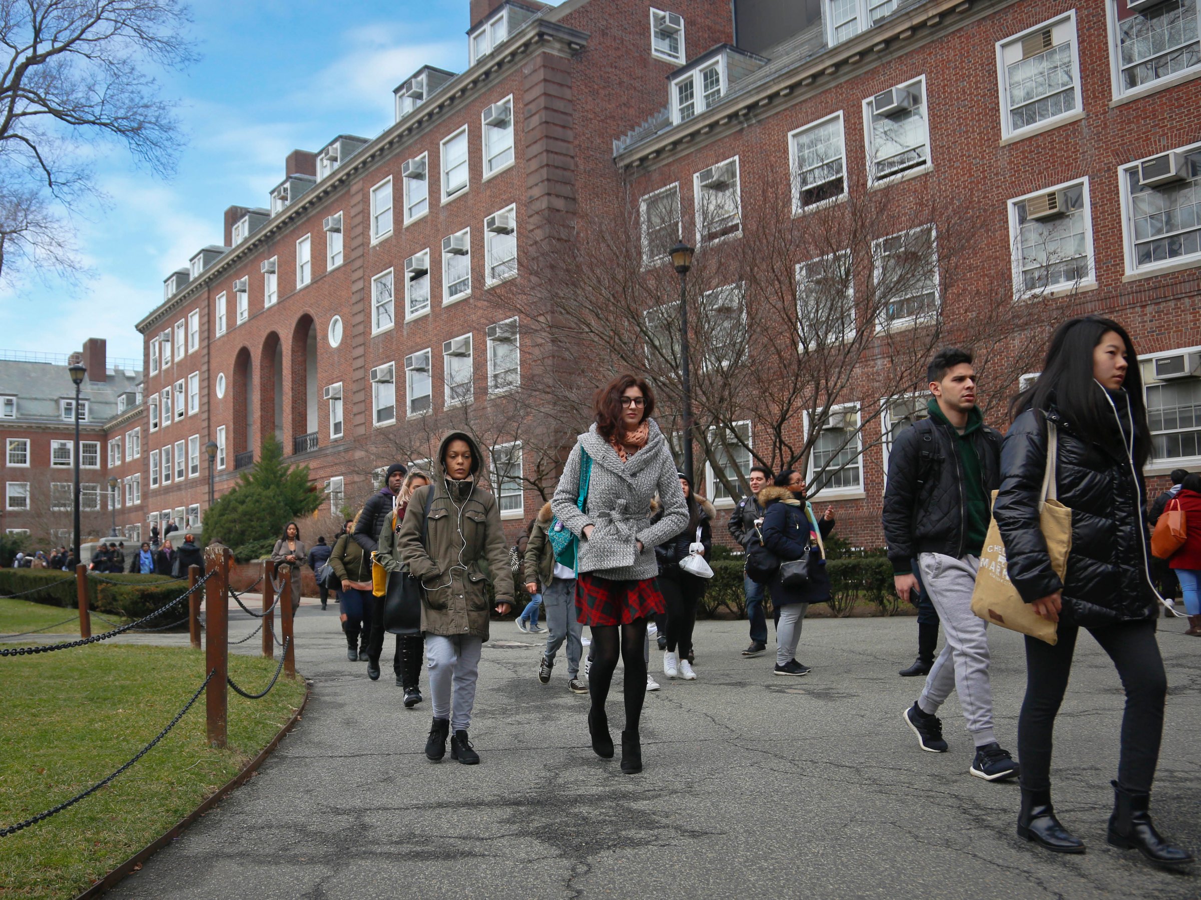 In this Wednesday, Feb. 1, 2017, photo, Brooklyn College students walk between classes on campus, in New York. The students say a proposal to make college tuition-free for middle-class students at New York public universities would provide welcome financial help, but note that free tuition doesn't mean free college because of the expense of things like room and board and books.