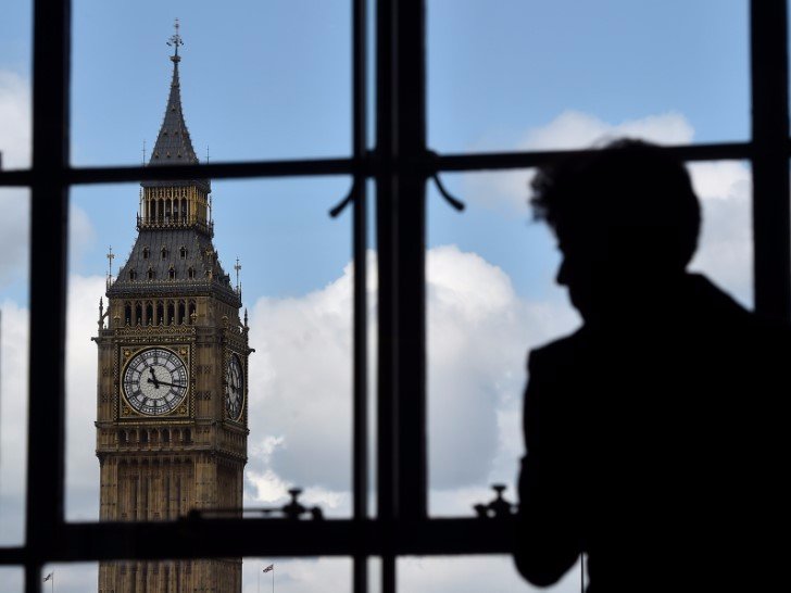 A woman looks out of a window at the Big Ben clock tower in London, Britain, April 26, 2017. REUTERS/Hannah McKay