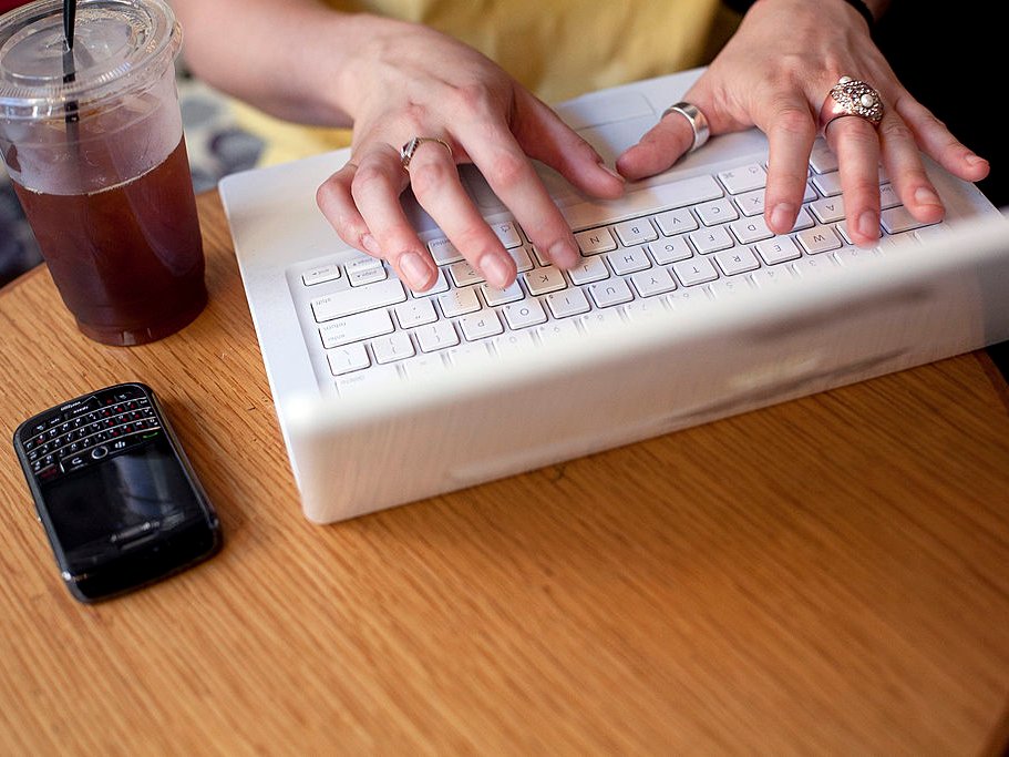 working computer hands typing coffee