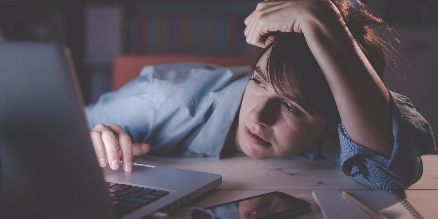 burnout tired sleepy exhausted woman office desk laptop eyes closing fall asleep sleep deprivation overtime work