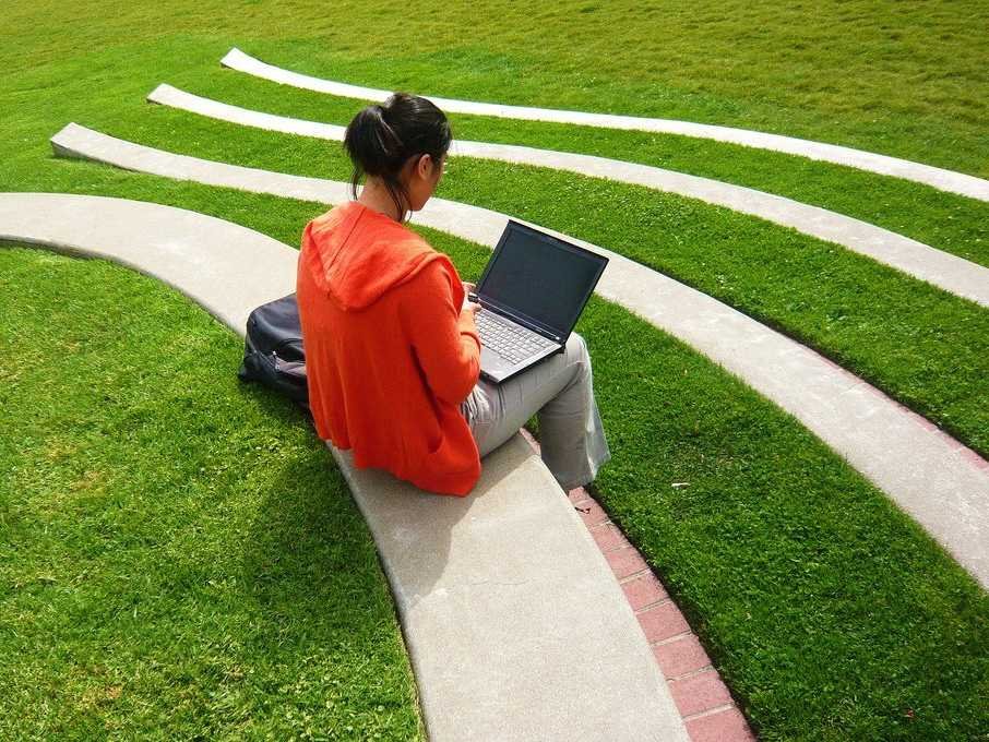 student studying laptop outside