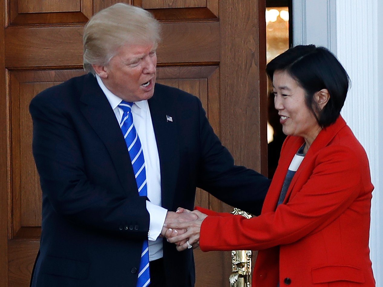 President-elect Donald Trump shakes hands with Michelle Rhee, a former chancellor of Washington, D.C., schools, and her husband, former NBA basketball player Kevin Johnson, left, as they leave Trump National Golf Club Bedminster clubhouse in Bedminster, N.J., Saturday, Nov. 19, 2016.