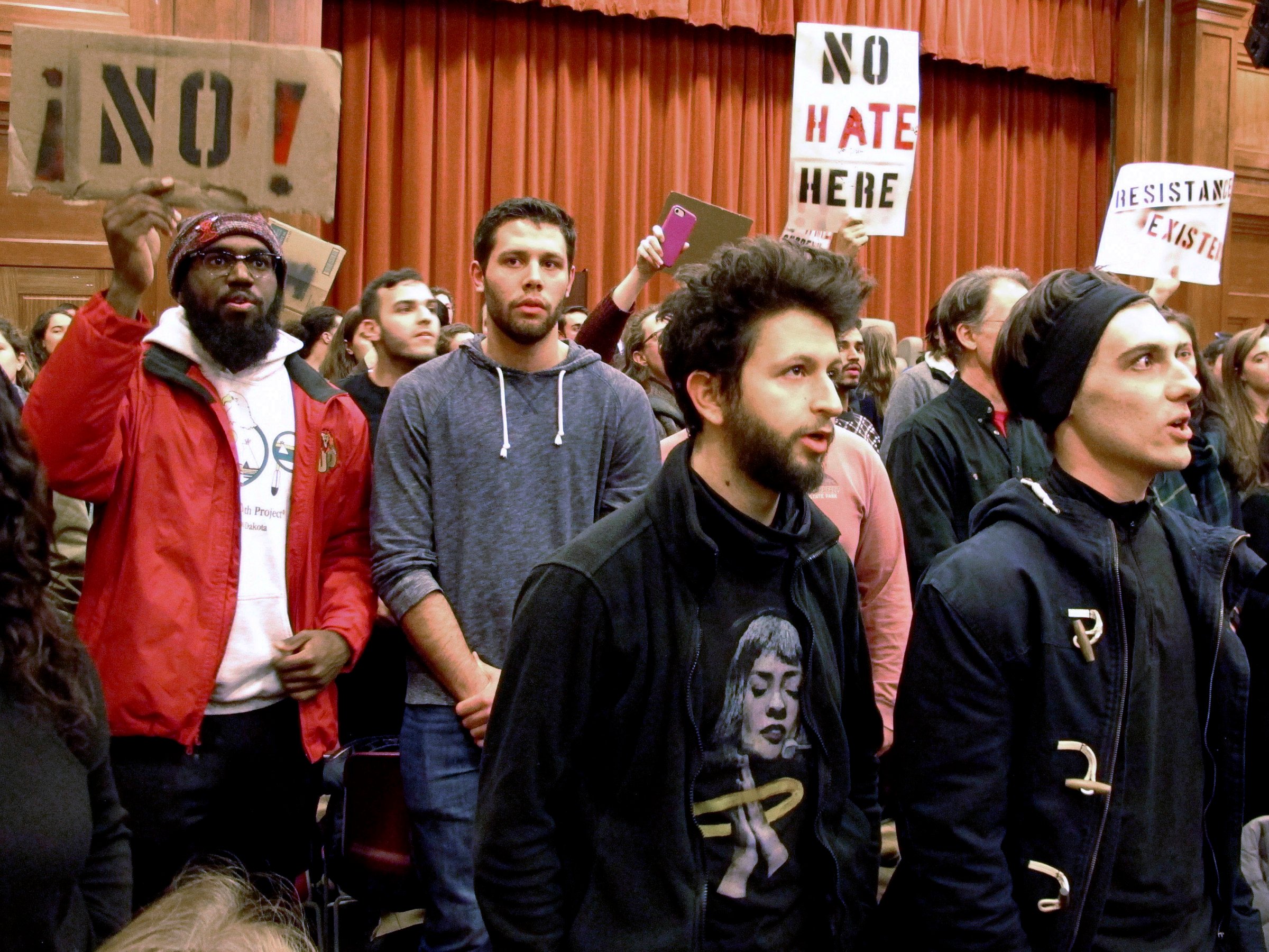 In this March 2, 2017, file photo, Middlebury College students turn their backs to Charles Murray, unseen, during his lecture in Middlebury, Vt. Hundreds of students protested his lecture, forcing the college to move his talk to an undisclosed campus location from which it was live-streamed to the original venue. Since the beginning of 2016, more than two dozen campus speeches have been derailed amid controversy, according to the Foundation For Individual Rights In Education, a group that monitors free speech on campuses.