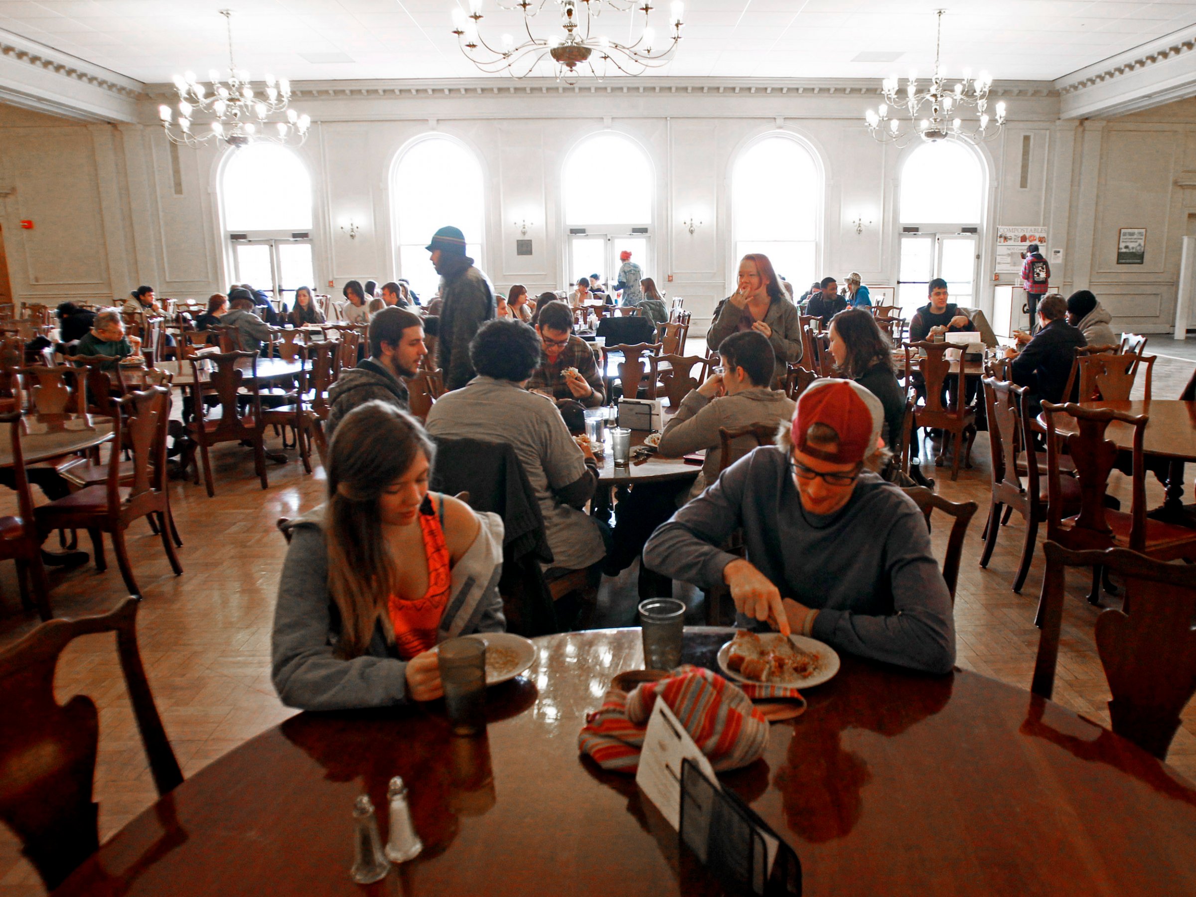 In this Thursday, Nov. 8, 2012 photo, students eat lunch in the dining hall at Green Mountain College, in Poultney, Vt. To officials at the small Vermont liberal arts college, a decision to slaughter two retired oxen and serve the meat in its dining halls is a matter of sustainable agriculture. But now, the school is under attack by those who want the oxen spared and have found a sanctuary for the animals. Opponents have signed online petitions and sent thousands of emails to staff members. The school received more than 3 million emails from Oct. 13 to Oct. 18 from one Internet domain, and got 200 emails from Spain, officials said.