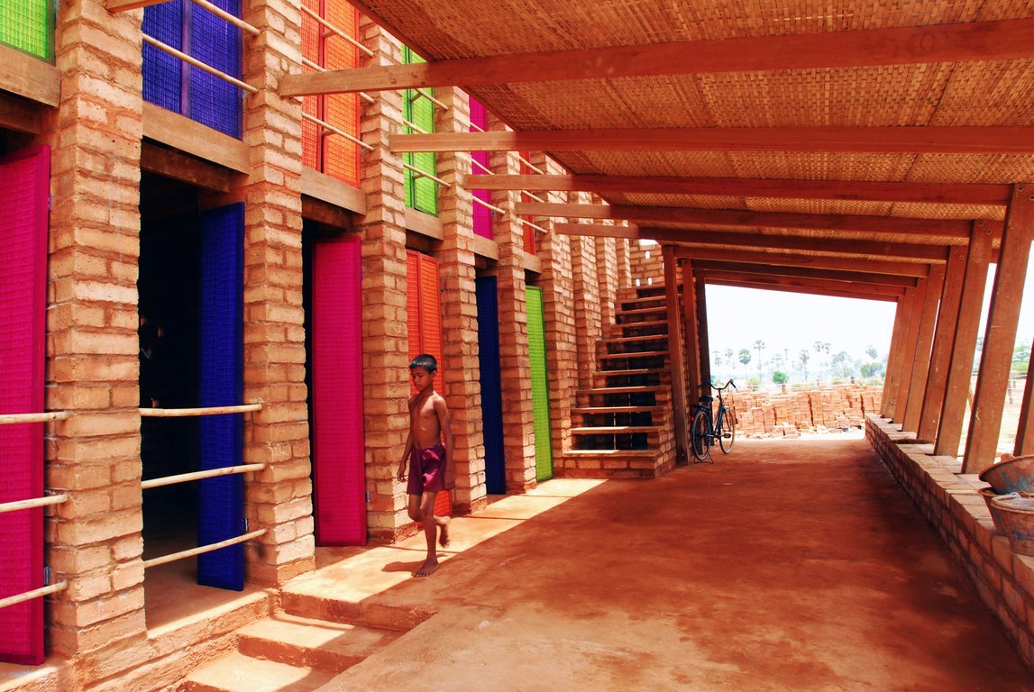 Colors pop at the Sra Pou Vocational School in Cambodia. Villagers can visit the brick building to learn arithmetic or how to start a small business.