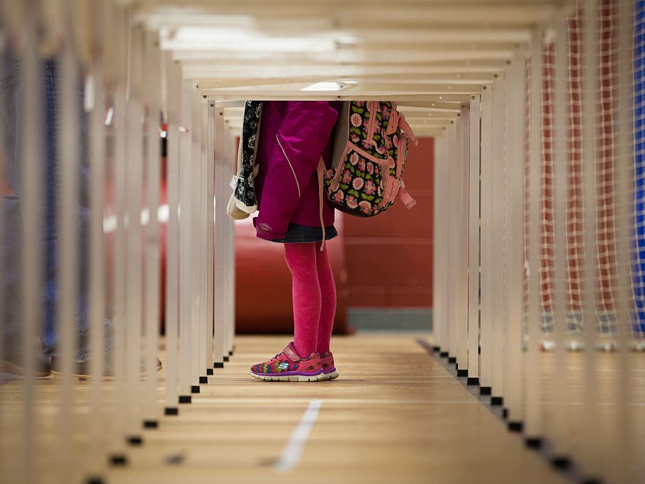 A child stands inside a voting booth on February 9, 2016 at Broken Ground School in Concord, New Hampshire. . Voters throughout the state are heading to the polls as the New Hampshire Primary, also known as the first-in-the-nation primary, continues the process of selecting the next president of the United States. (Photo by Matthew Cavanaugh/Getty Images)