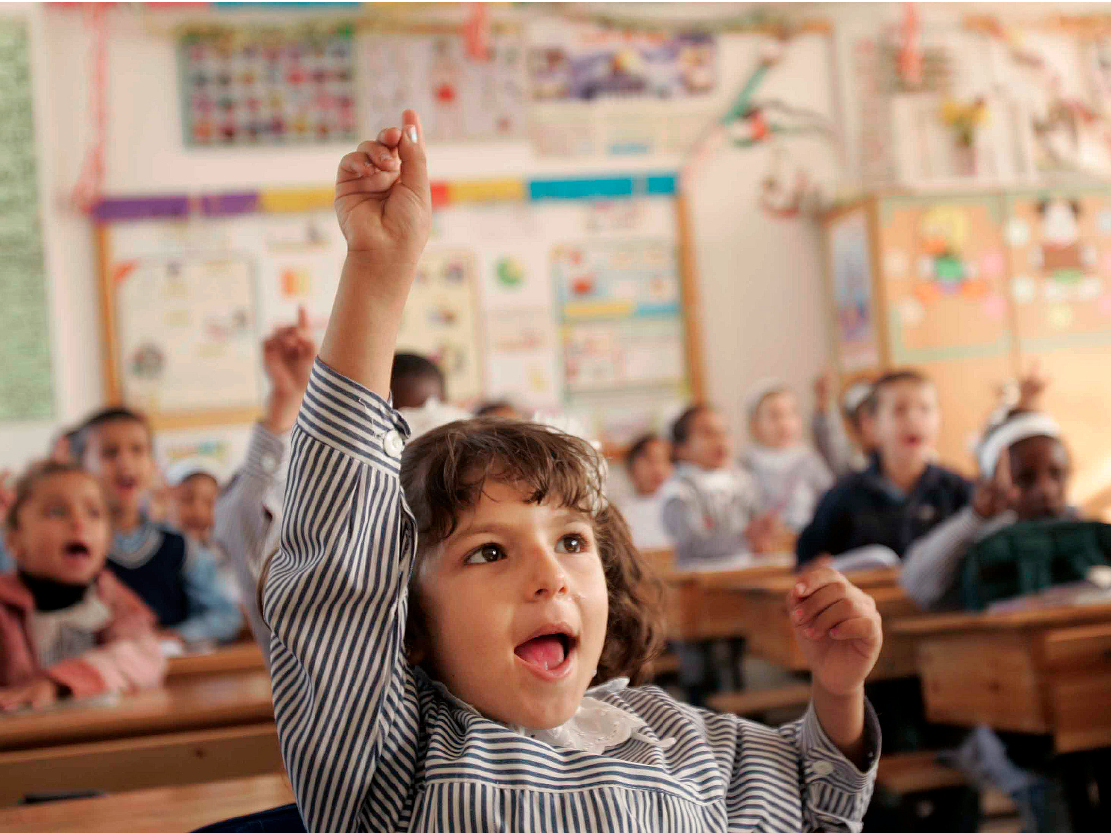 Student raising hand asking question girl