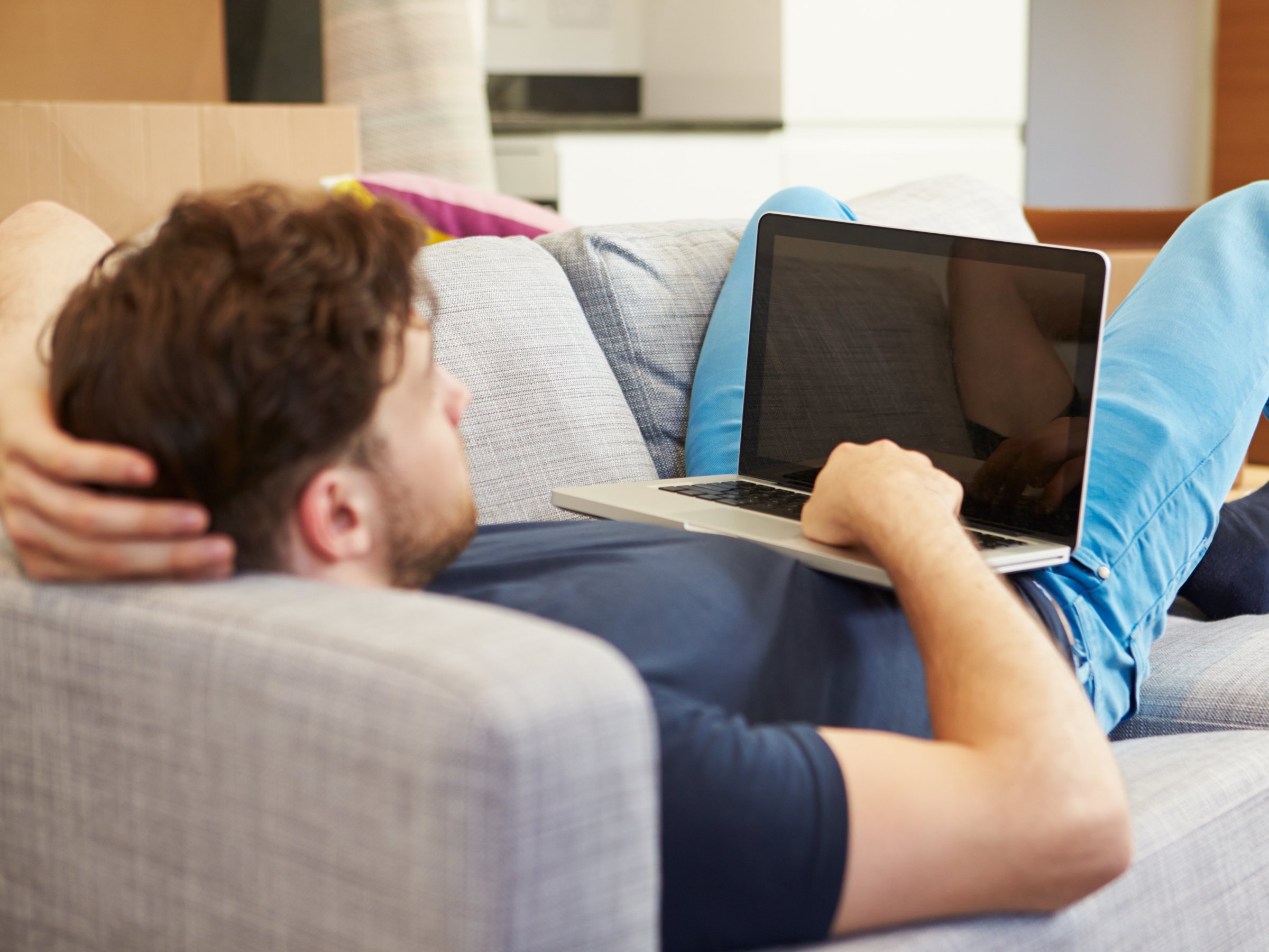 man on laptop on couch