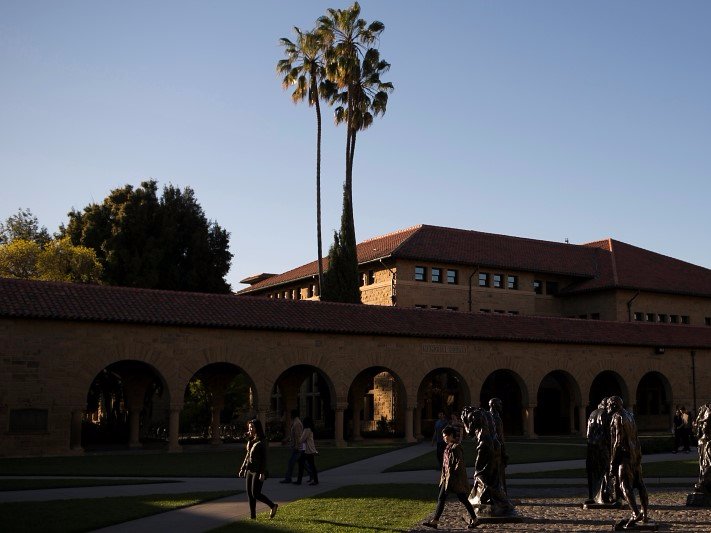 Pedestrians walk past a group of statues at Stanford University in Stanford, California March 11, 2014.  REUTERS/Stephen Lam