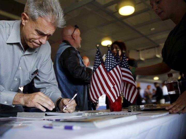 A job seeker fills out papers at a military job fair in San Francisco, California, August 25, 2015. The employment workshop, held by the U.S. Chamber of Commerce Foundation, attracted hundreds of veterans and 115 companies. REUTERS/Robert Galbraith - RTX1PN8R
