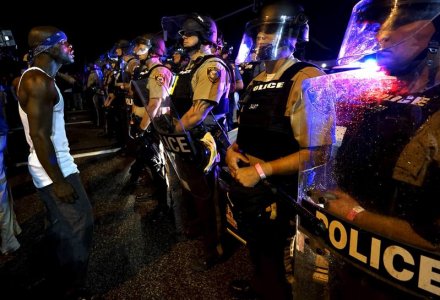 A protester yells at a police line shortly before shots were fired in a police-officer involved shooting in Ferguson, Missouri August 9, 2015.   REUTERS/Rick Wilking/File Photo